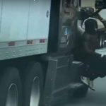 Man Filmed Hanging On To The Side Of Semi On The Freeway